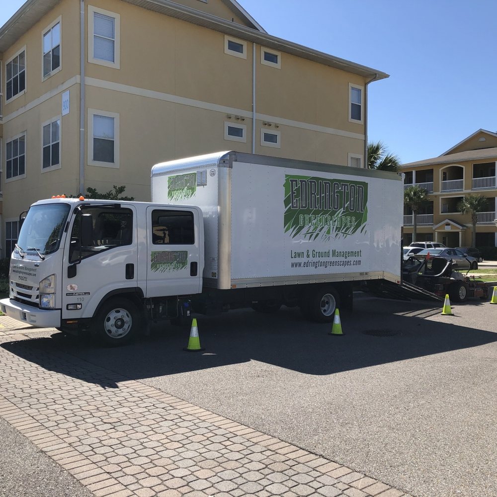 An Edrington Greenscapes crew truck on site at an apartment community