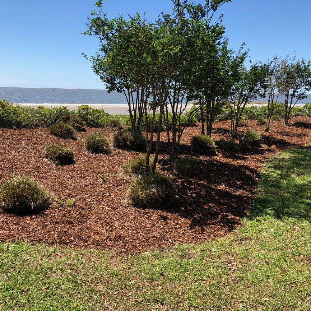 Fresh mulch beds and crepe myrtles at a waterfront property